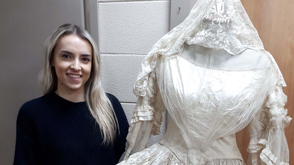 Jess Boam from Richard Winterton Auctioneers with the 126-year-old wedding dress